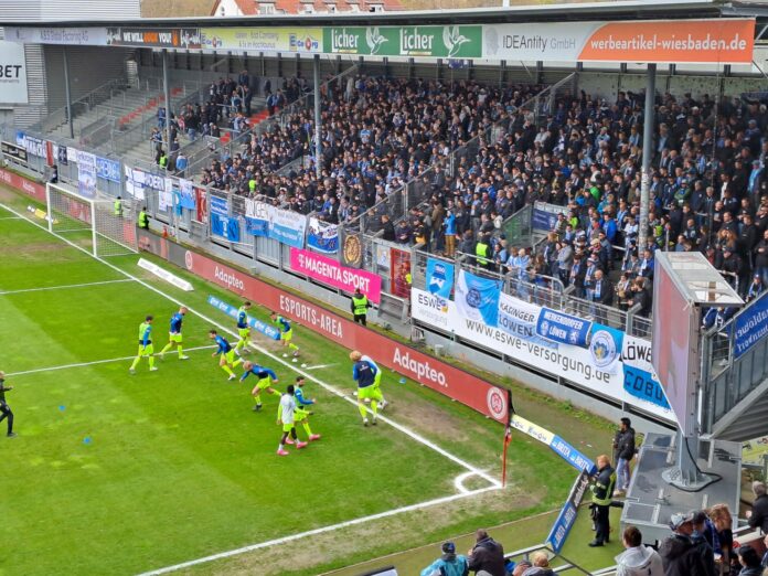 Die Kurve der Fans des TSV 1860 auswärts in Wehen Wiesbaden.